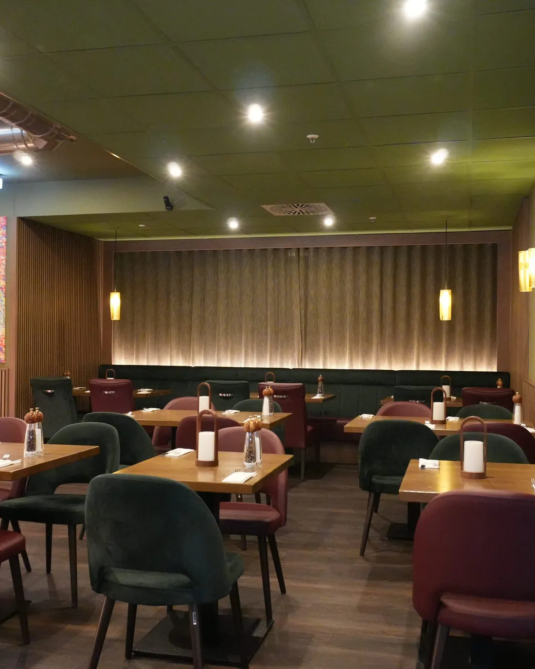Tische und goldener Pizzaofen im Gastraum der Osteria Siros in Hannover